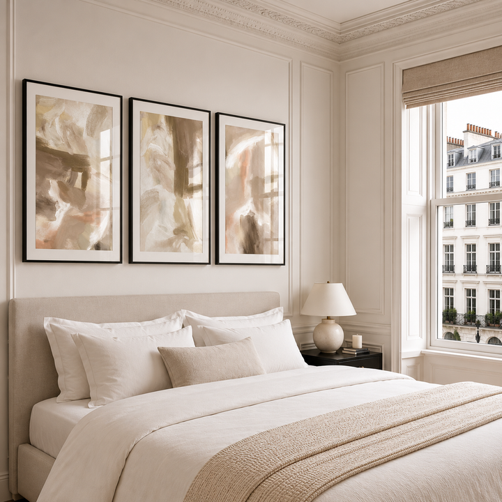 Neatly made bed in a bedroom with abstract art and a cityscape view.