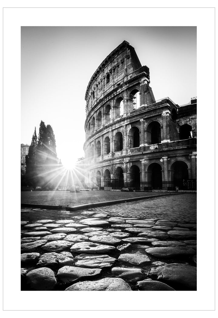 Black and white image of the Colosseum with sunlight shining through