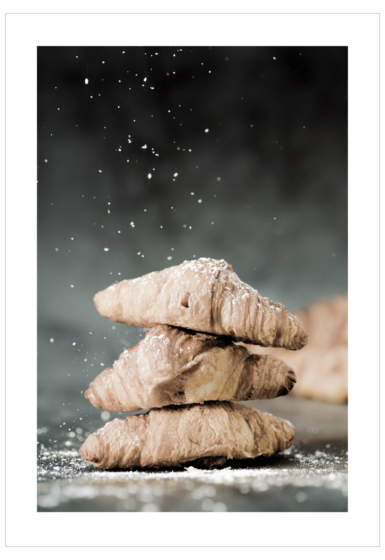 Stack of powdered sugar cookies on a dark background