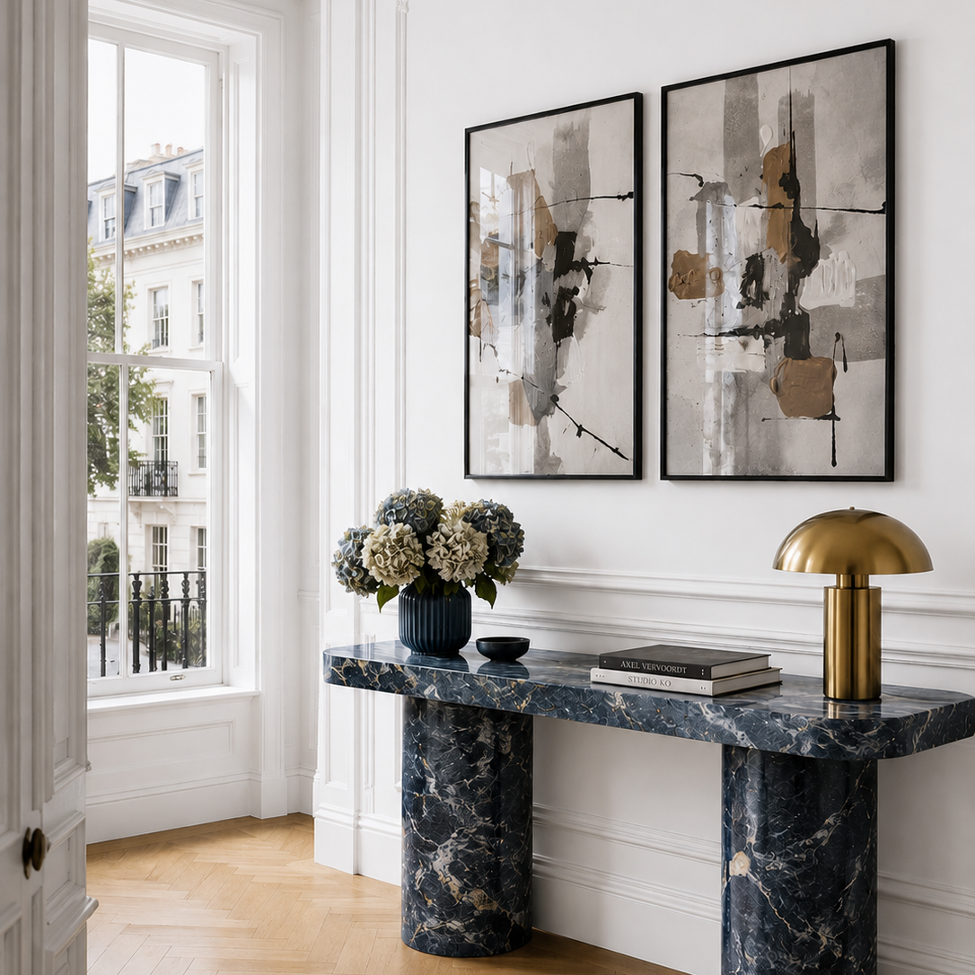 Modern interior with a marble console table, abstract art, and decorative items.