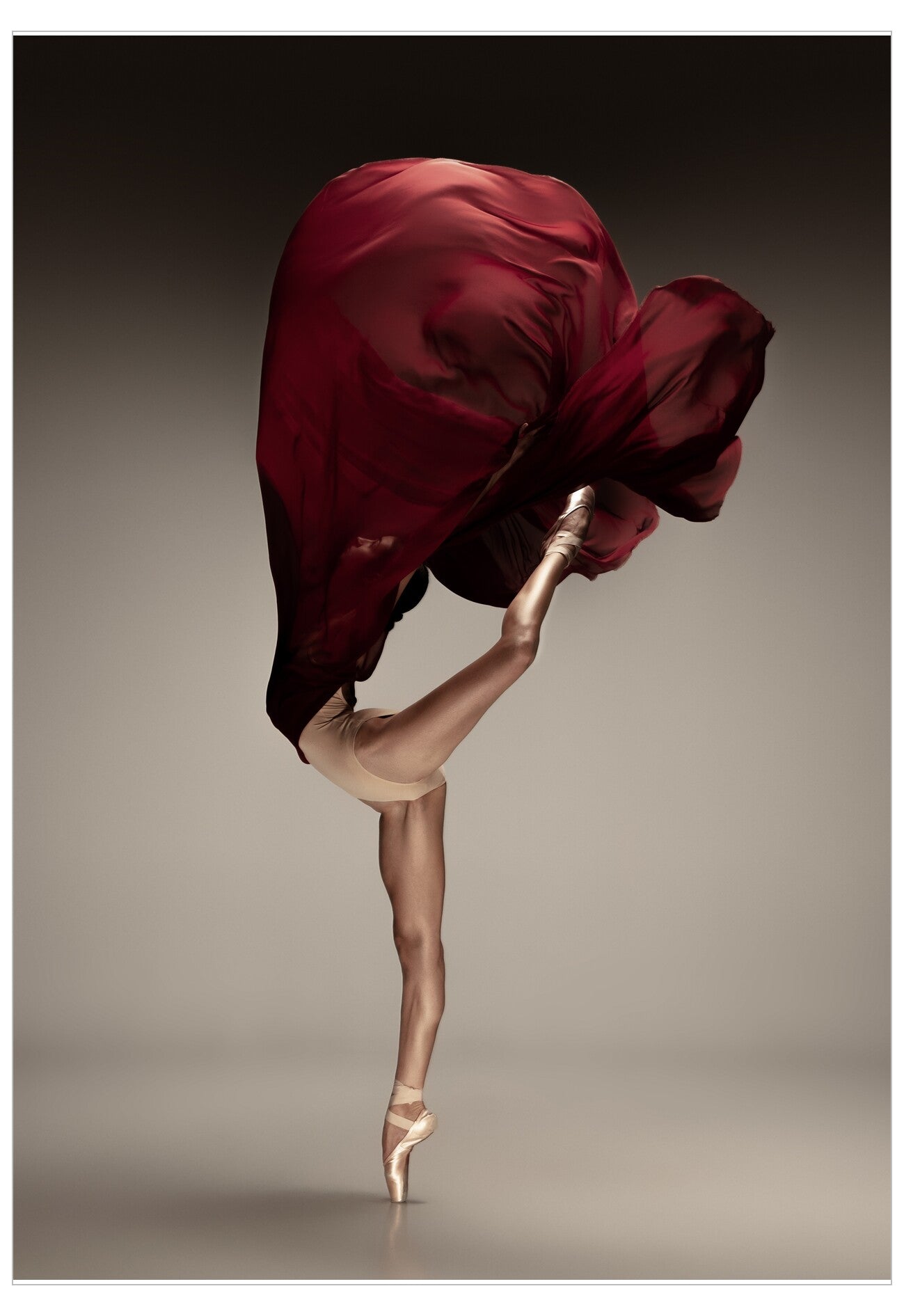 Dancer in a red skirt performing a pose on a neutral background