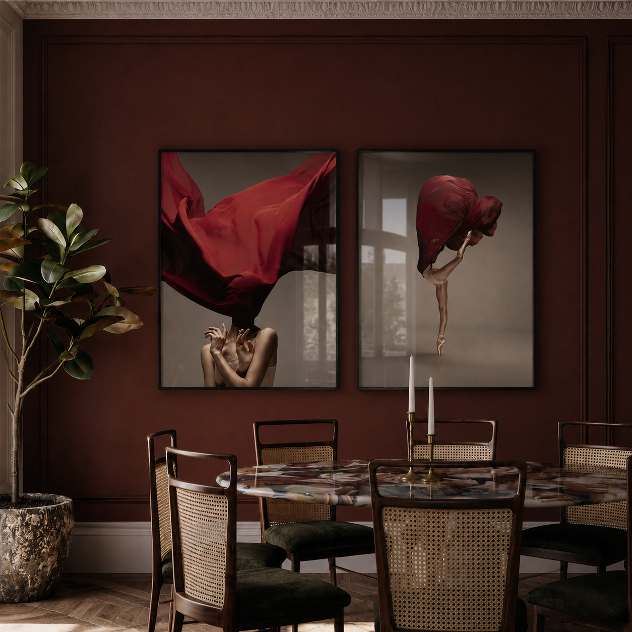 Dining room with a dark red wall, two abstract art pieces, a round table, and chairs.