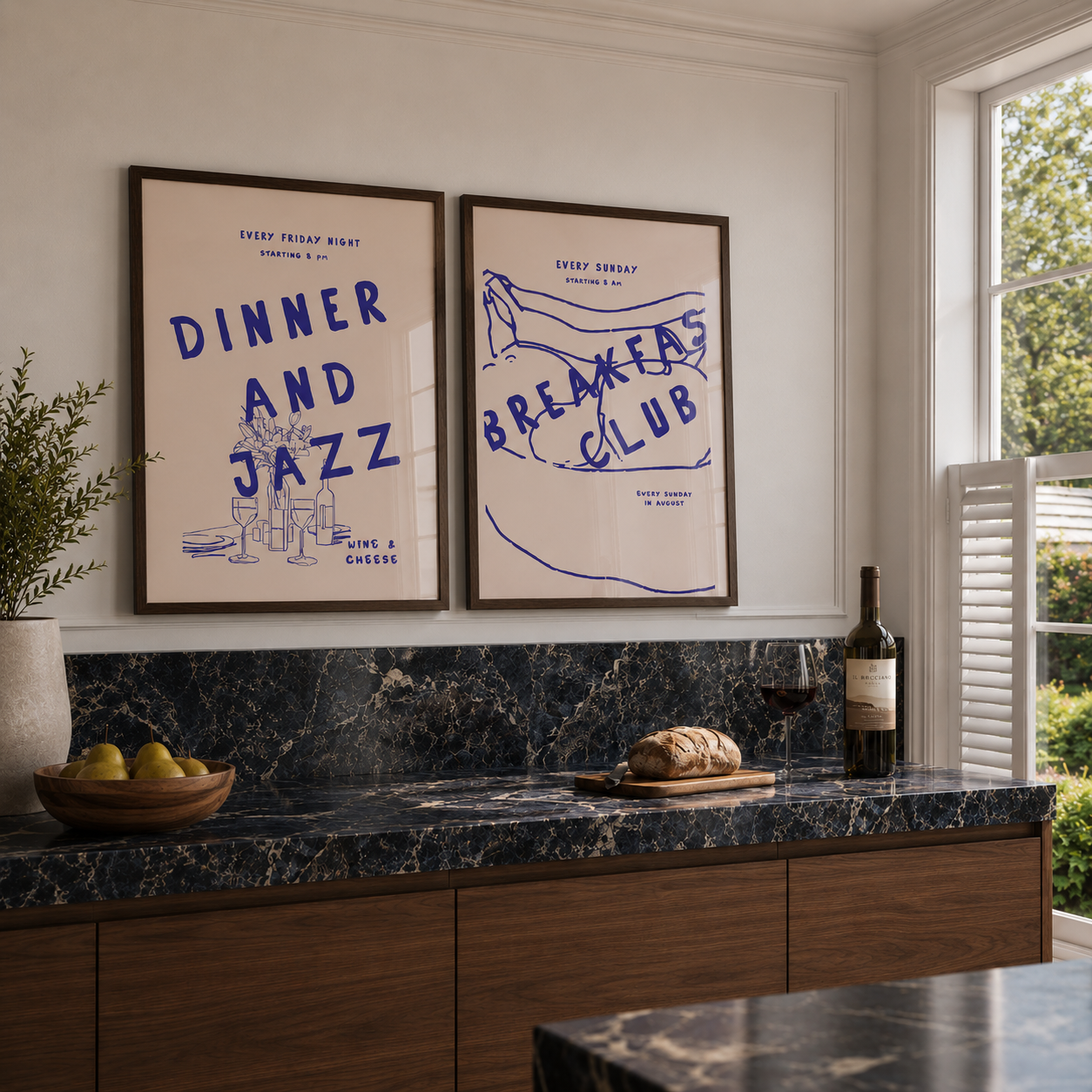 Modern kitchen with framed posters on the wall, marble countertop, and wine bottle.