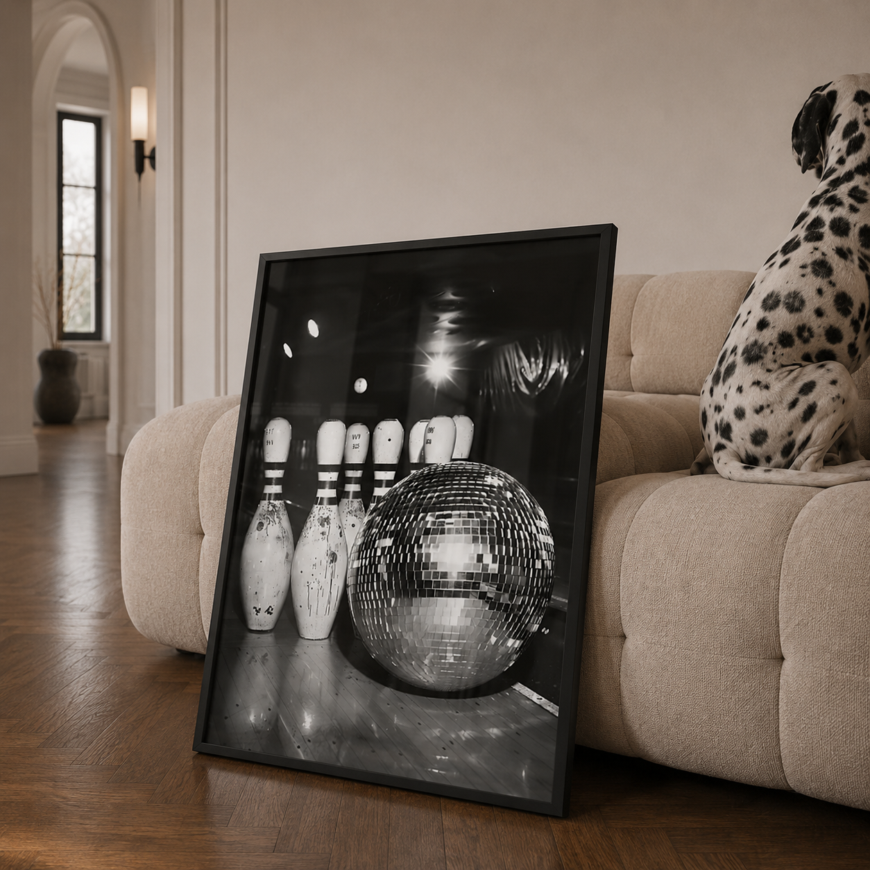 Framed black and white photograph of a disco ball and bowling pins on a couch with a Dalmatian.