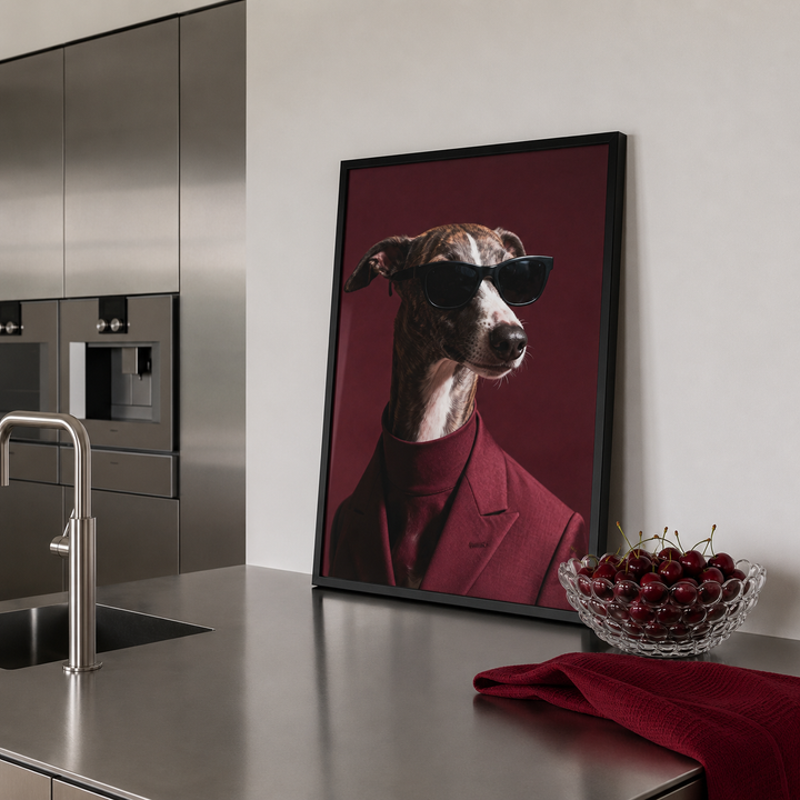 Framed picture of a dog wearing sunglasses on a kitchen counter with a bowl of cherries.