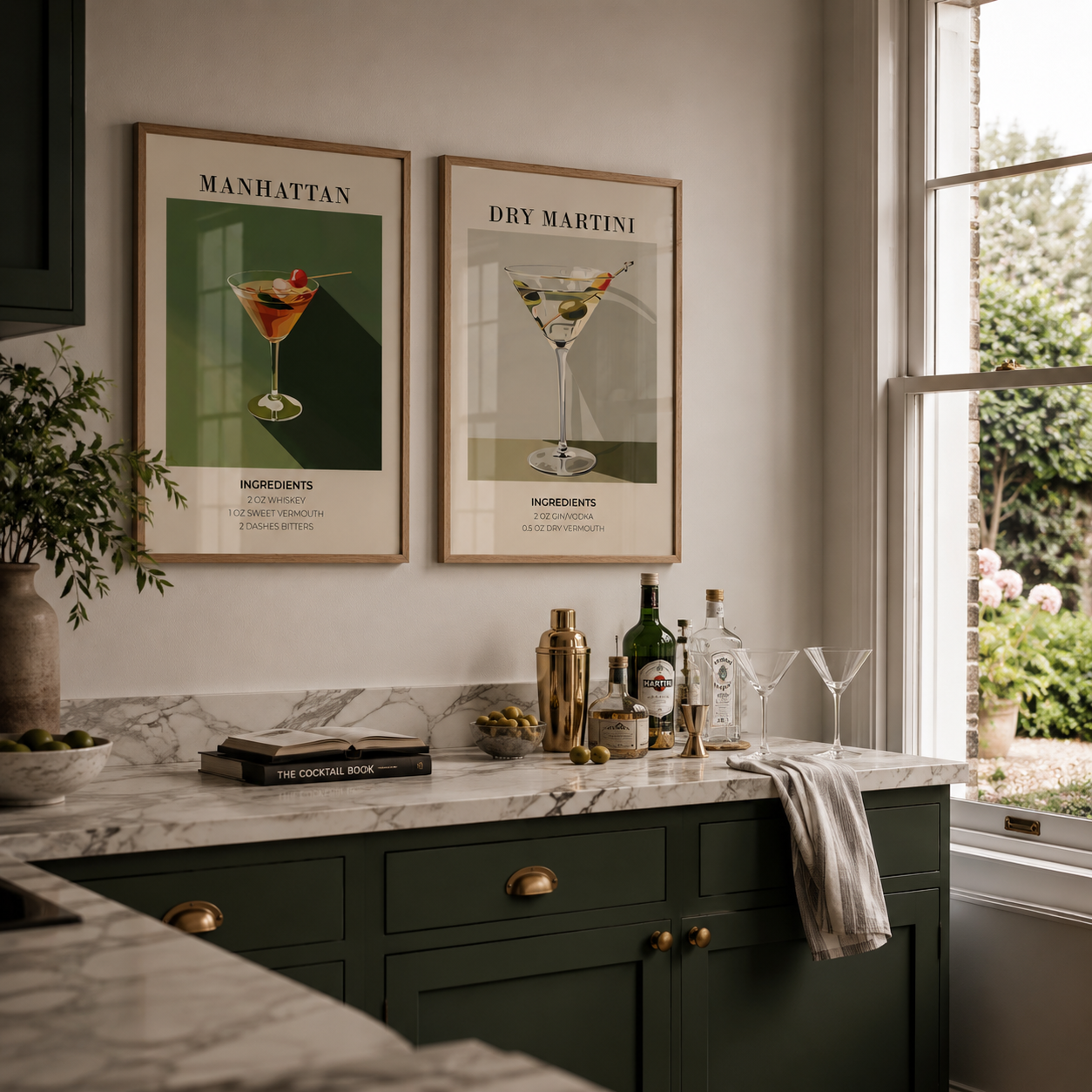 Modern kitchen with marble countertop, green cabinets, and framed cocktail posters.