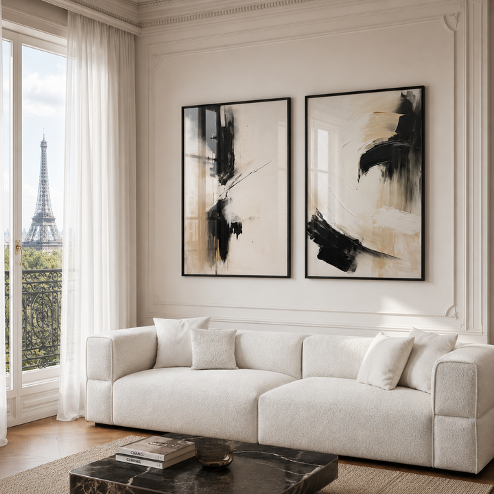 Modern living room with a white sofa, abstract art, and a view of the Eiffel Tower.