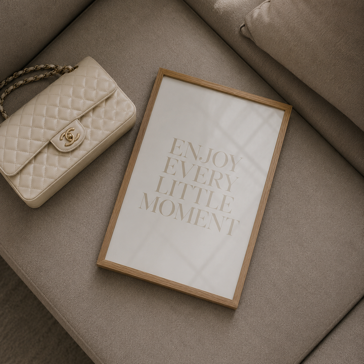 Quilted handbag and framed quote on a beige sofa