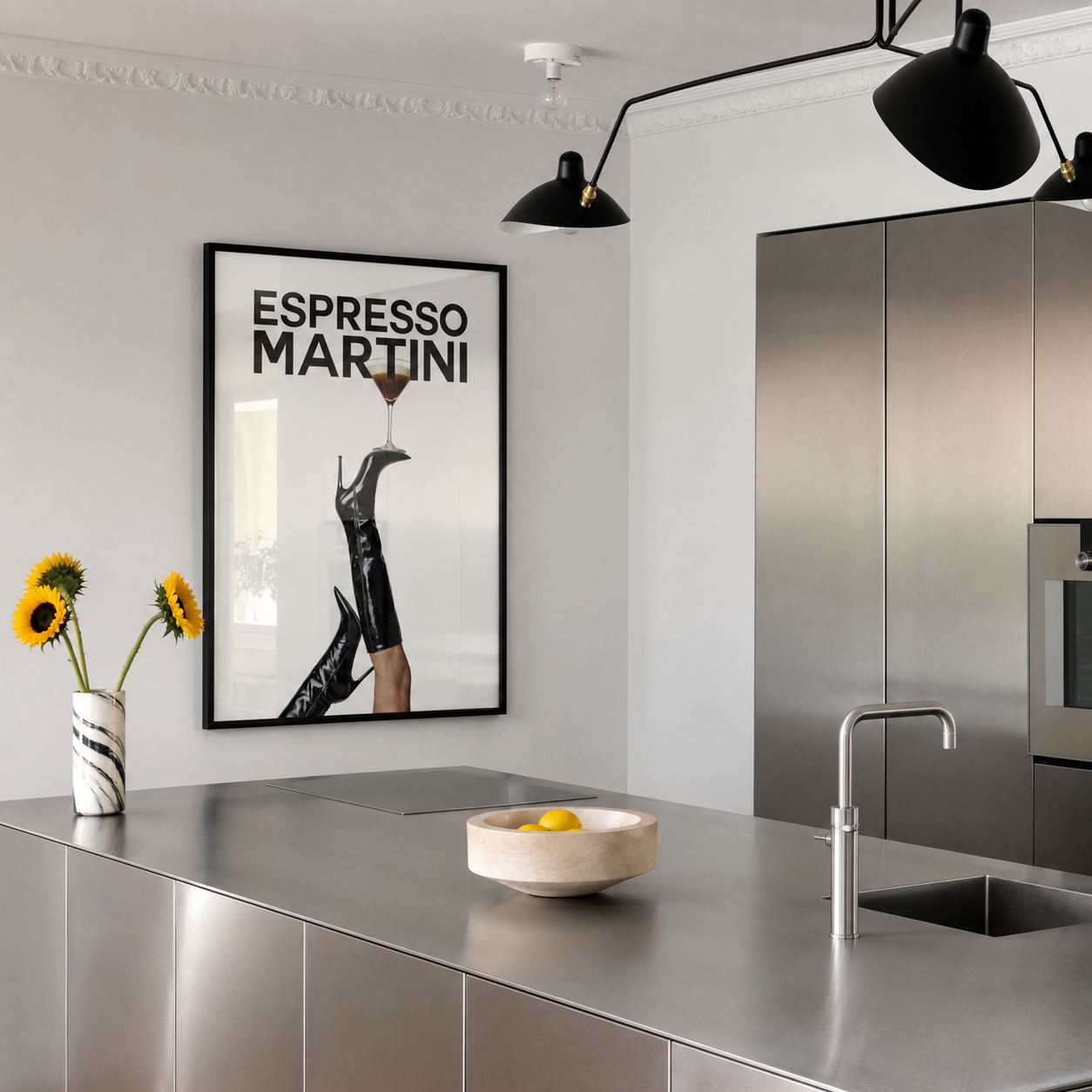 Modern kitchen with metallic island, black pendant lights, and 'Espresso Martini' poster.