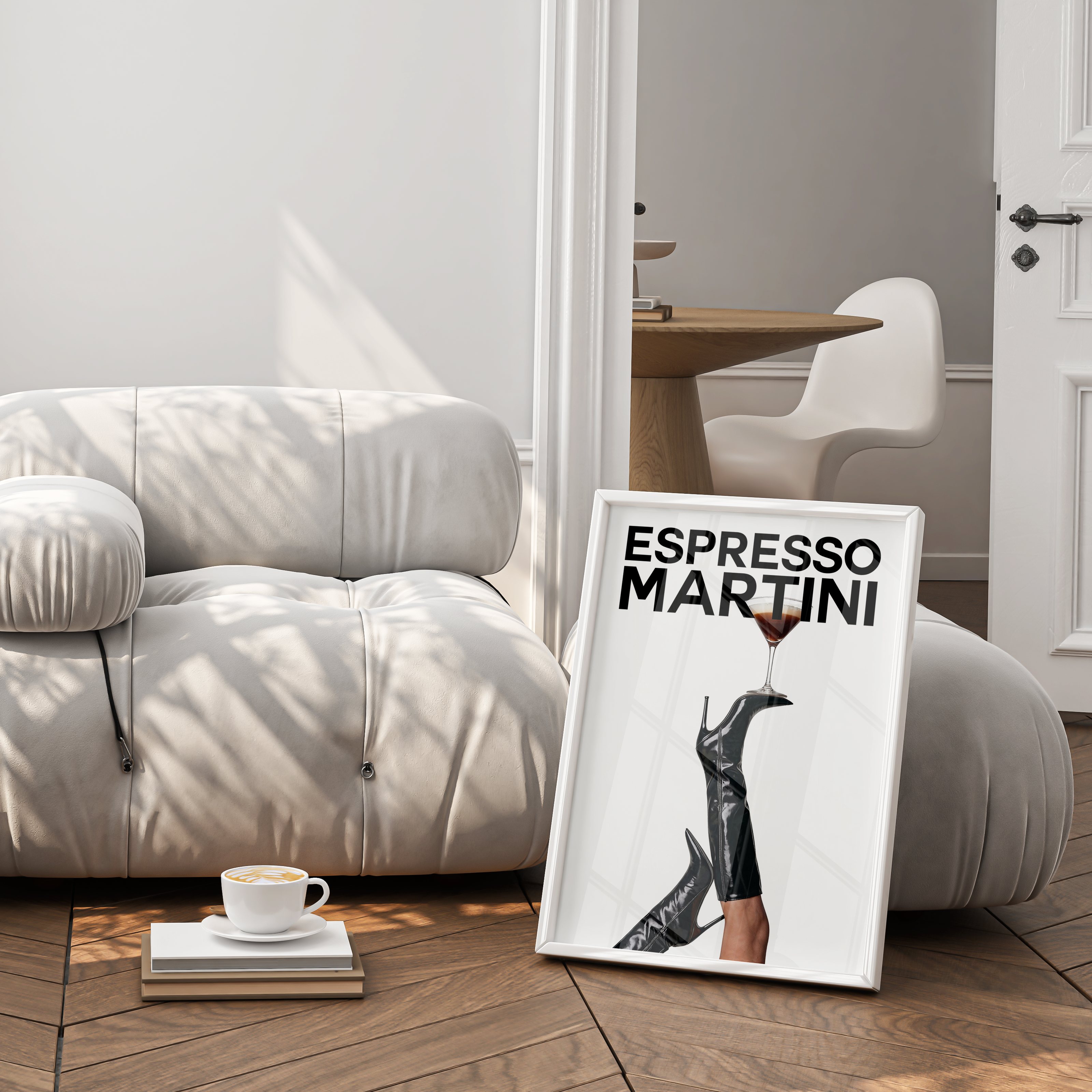 White armchair in a room with a framed picture of 'Espresso Martini' and a cup on a small table.