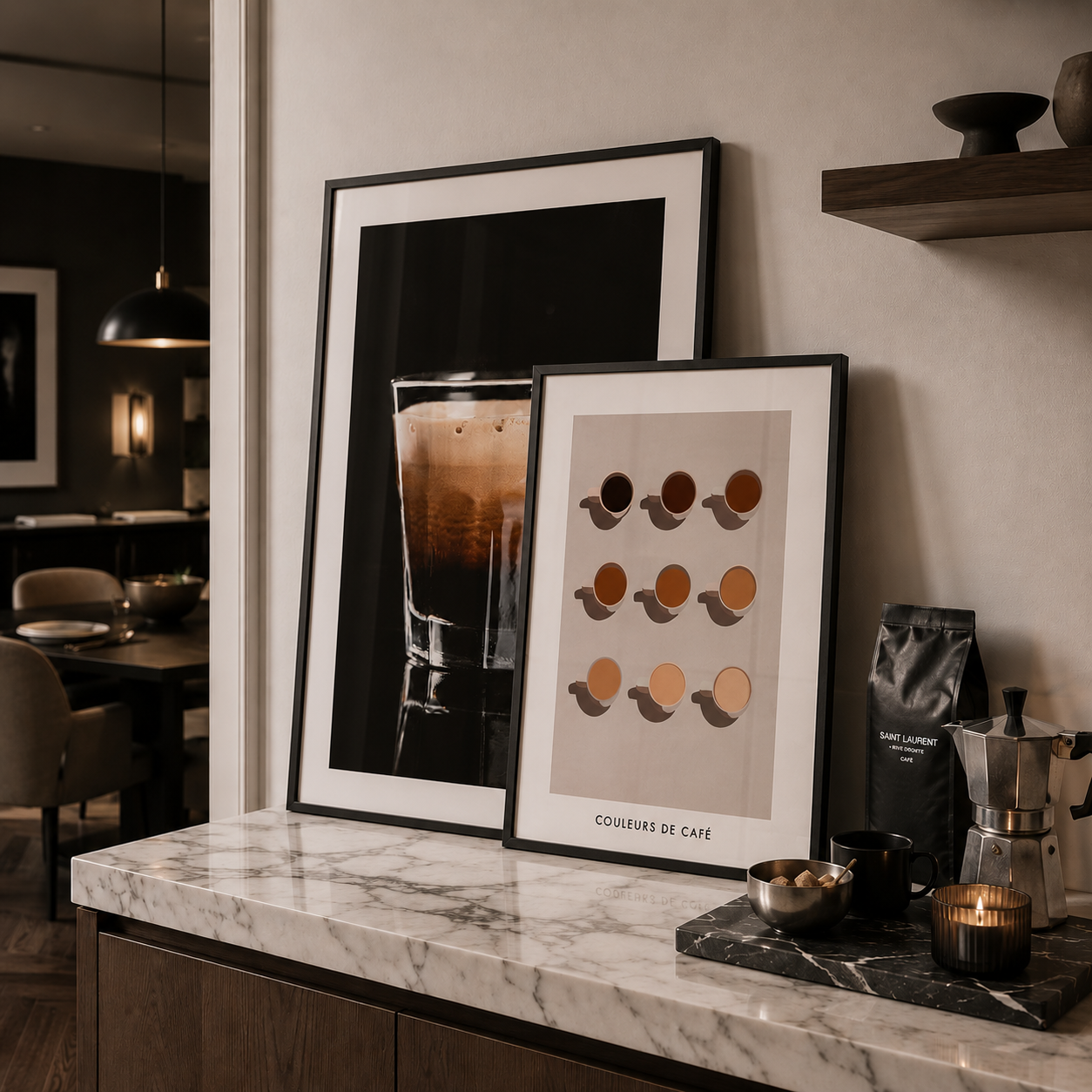 Framed coffee-themed prints on a marble countertop with coffee-making equipment.