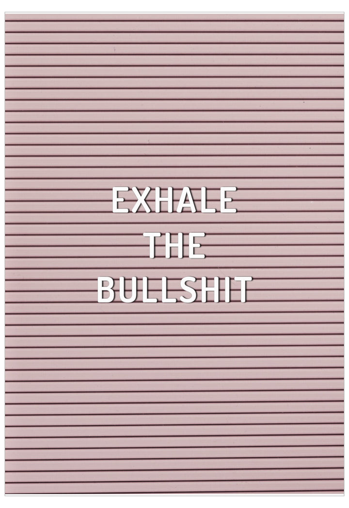 Pink letter board with 'EXHALE THE BULLSHIT' text