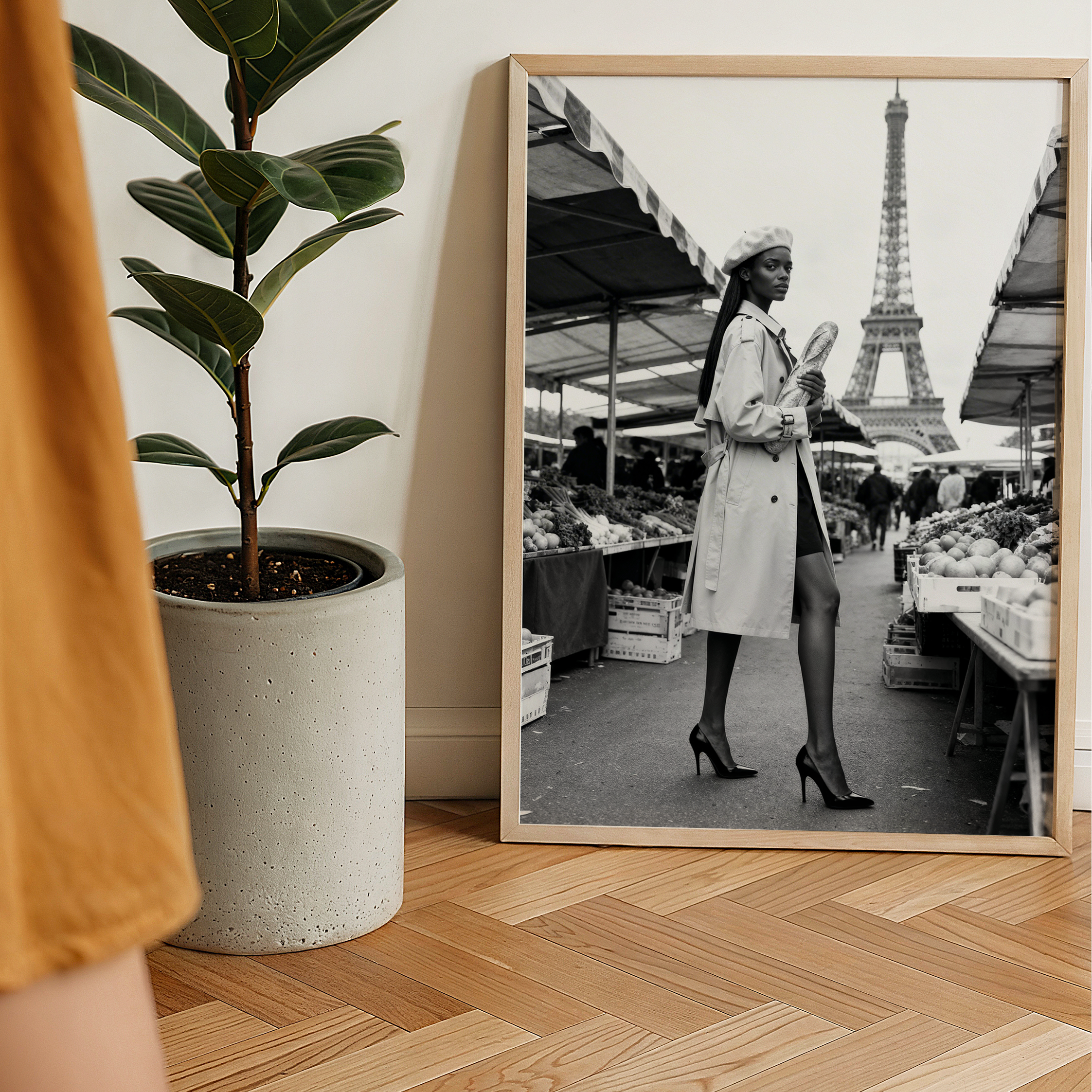 Person holding a mug with a plant and framed picture of the Eiffel Tower in the background