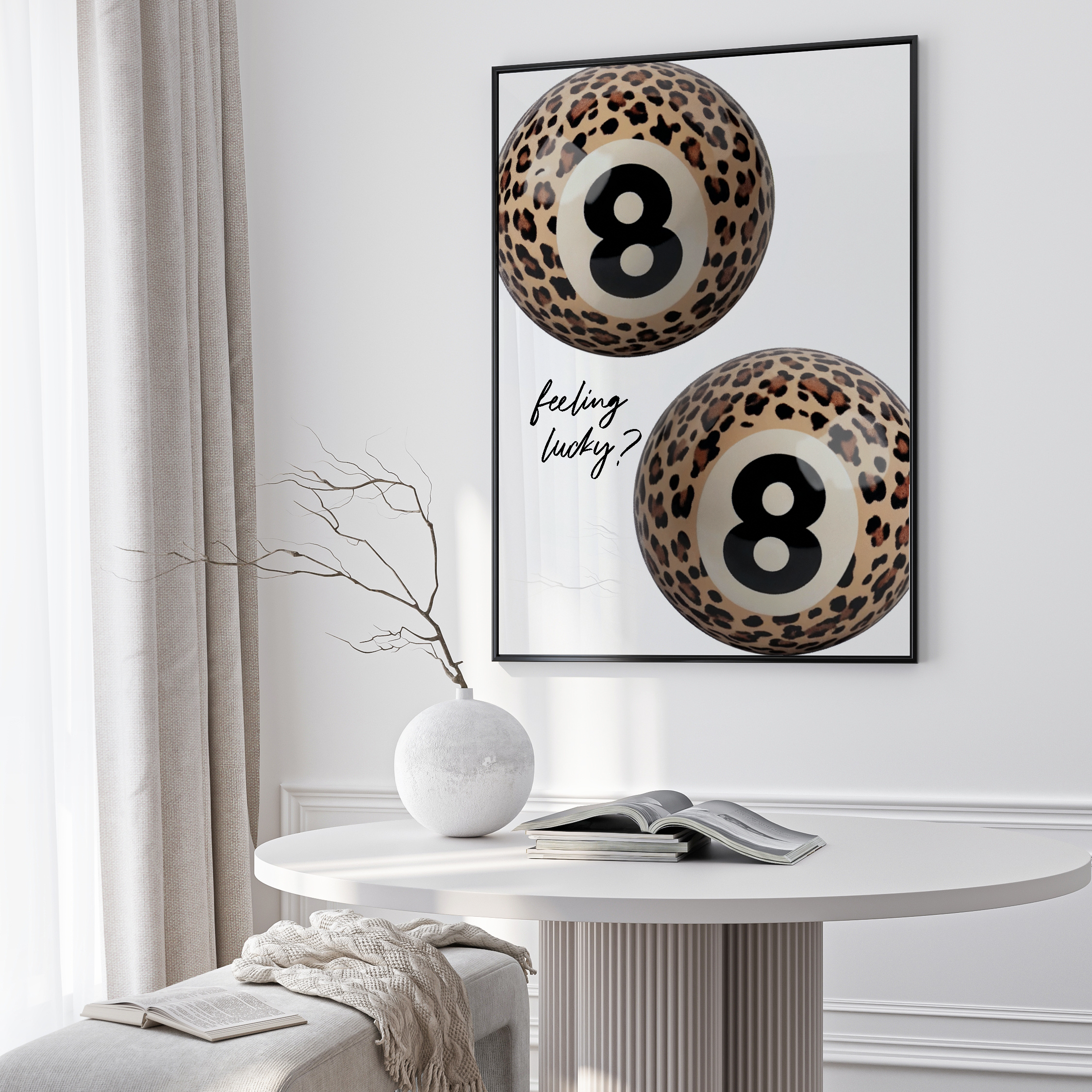 Framed artwork with leopard print numbers '8' on a wall above a table.