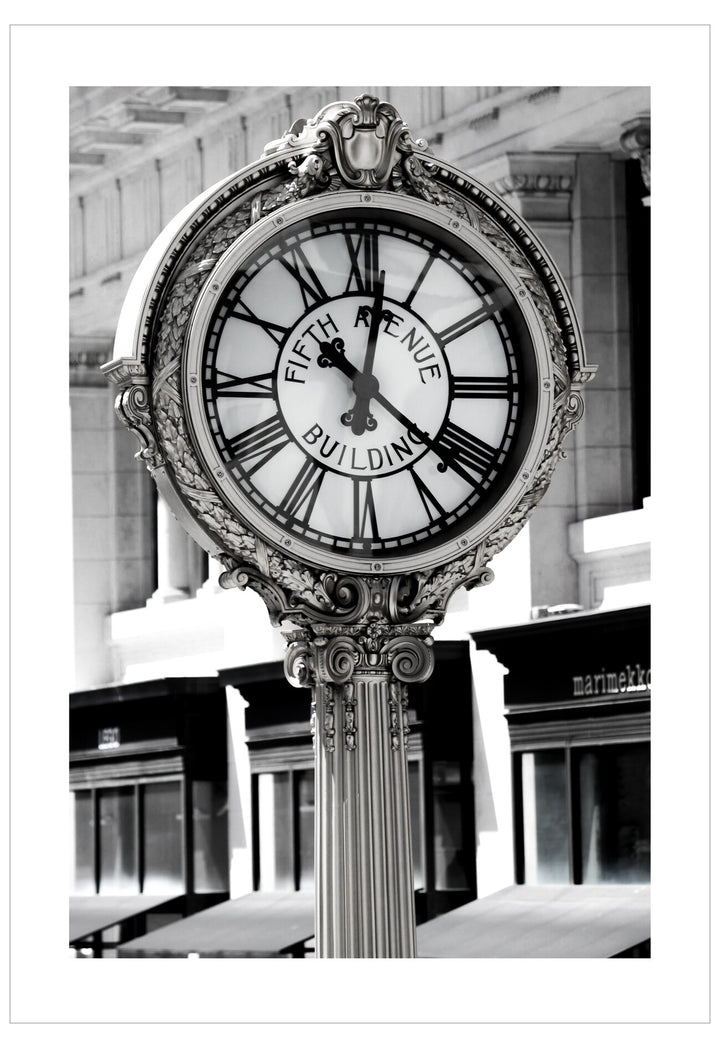 Decorative clock with 'Fifth Avenue Building' inscription in an indoor setting