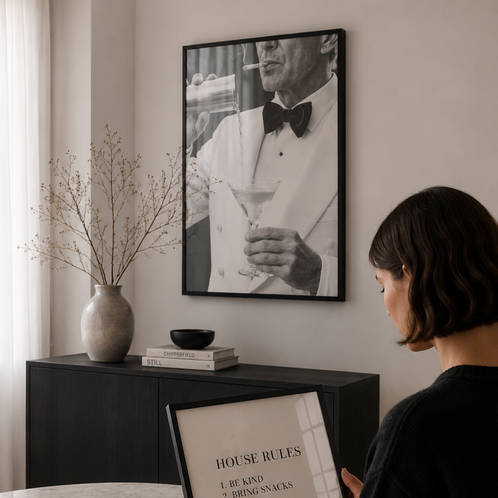 Woman reading a book titled 'House Rules' in a cozy room with a framed picture on the wall.