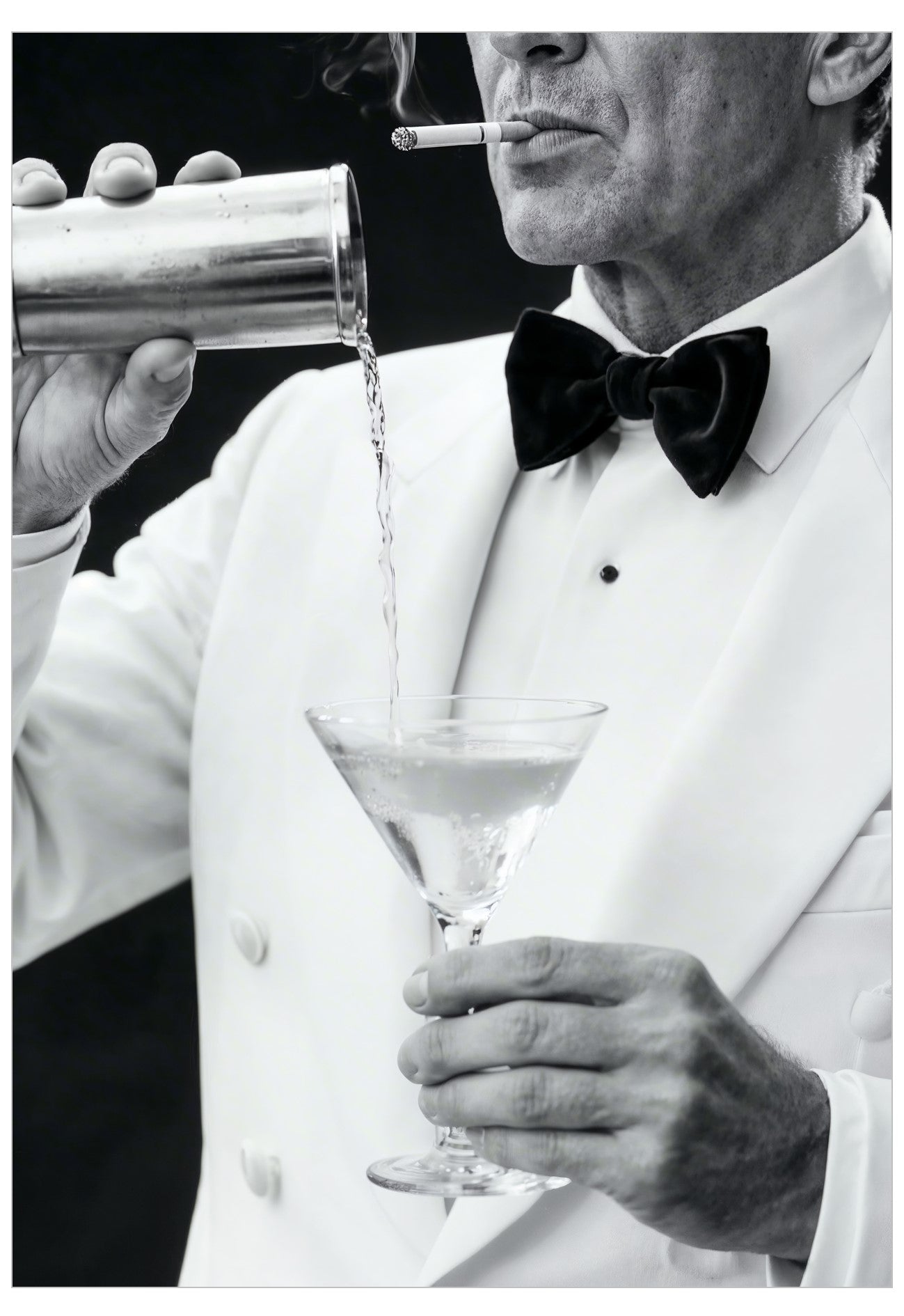 Man in a tuxedo pouring a cocktail into a glass with a cigarette in his mouth.