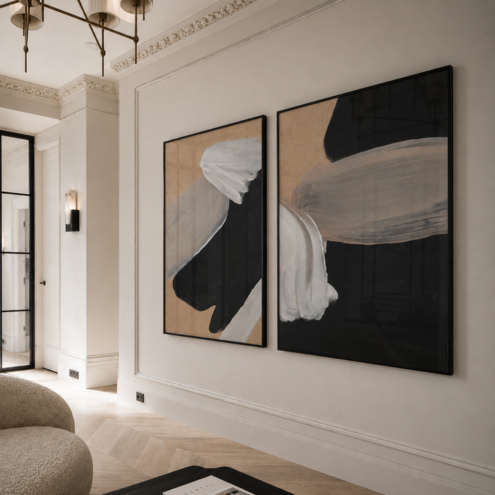 Two abstract paintings on a wall in a modern living room.