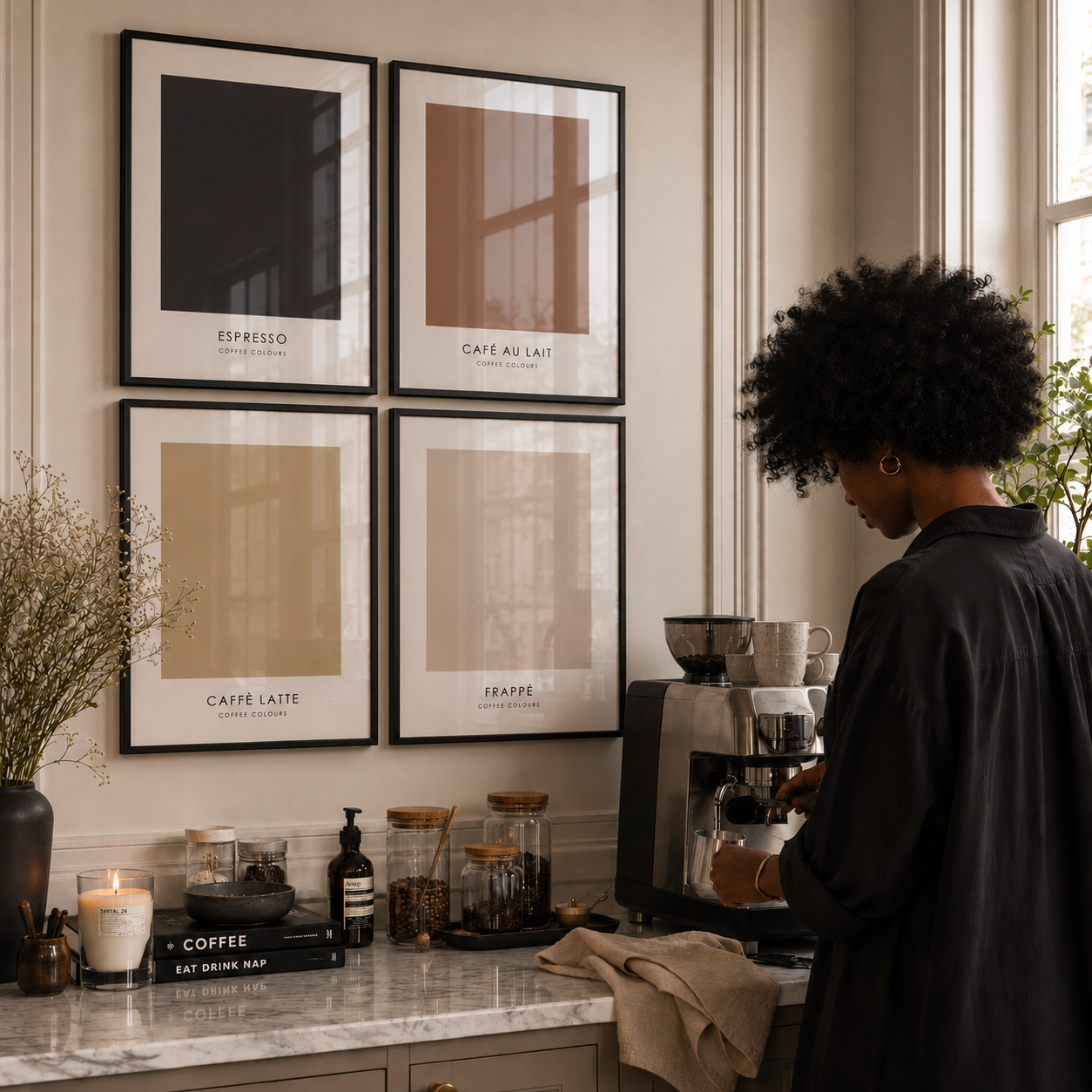 Person making coffee in a kitchen with framed coffee-themed prints on the wall.