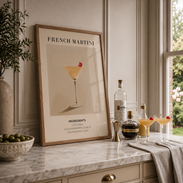 Framed poster of a French Martini recipe on a kitchen counter with bottles and glasses.