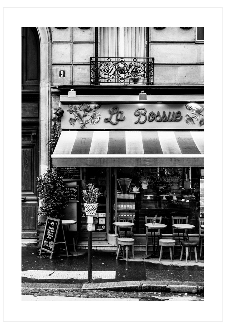 Black and white photo of a cafe named 'La Bosnie' with striped awning.