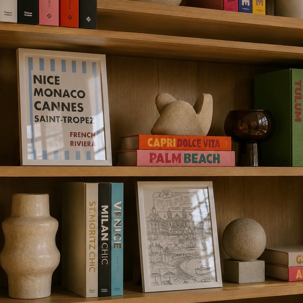 Posters of the French Riviera on stylish bookcase