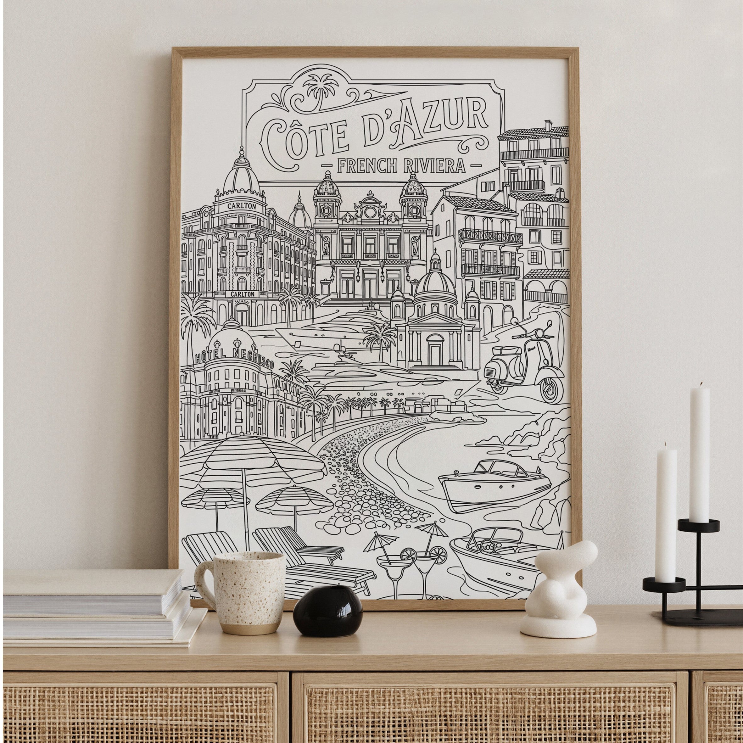 Framed artwork of Cète d'Azur, French Riviera on a wall above a wooden console table.