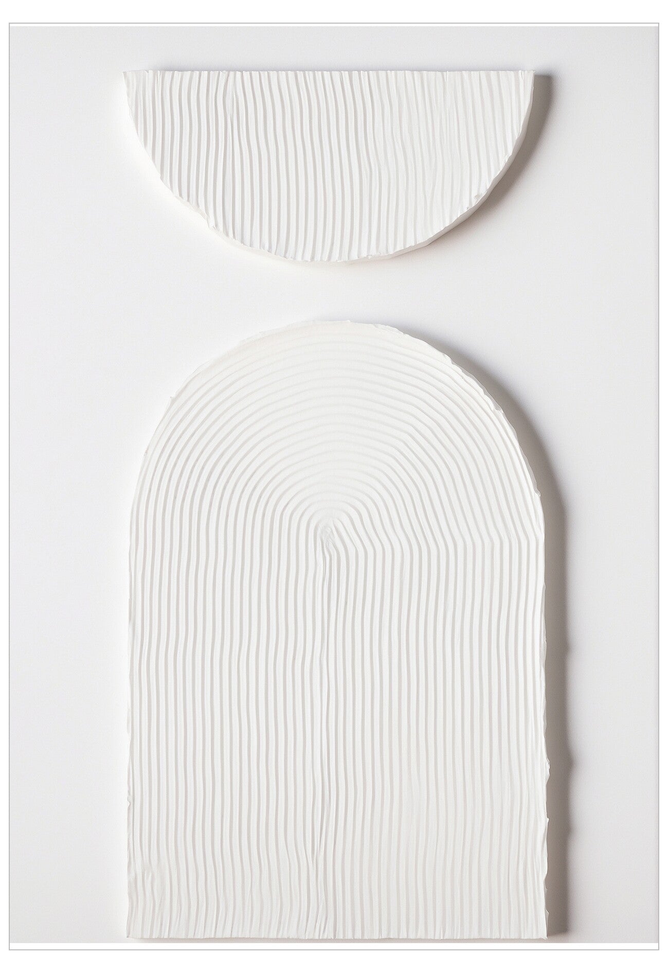 Two white textured oval objects on a light gray background