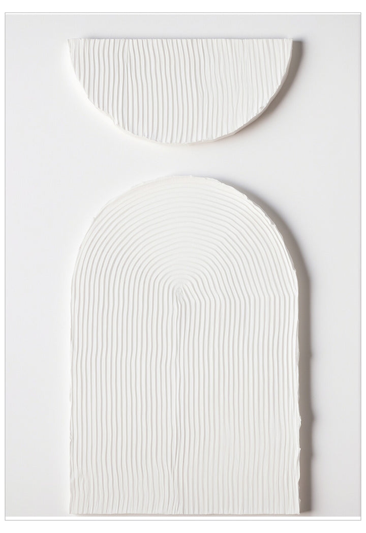 Two white textured oval objects on a light gray background