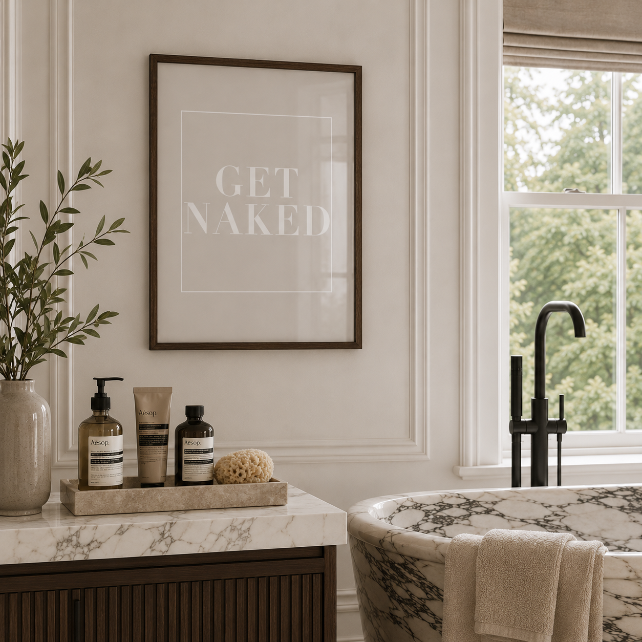 Bathroom interior with a bathtub, toiletries, and a framed quote on the wall.