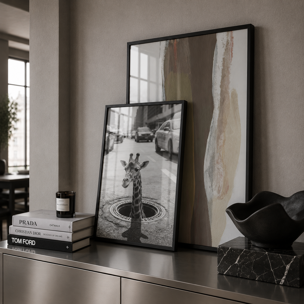 Framed artwork on a shelf with books and decorative items.