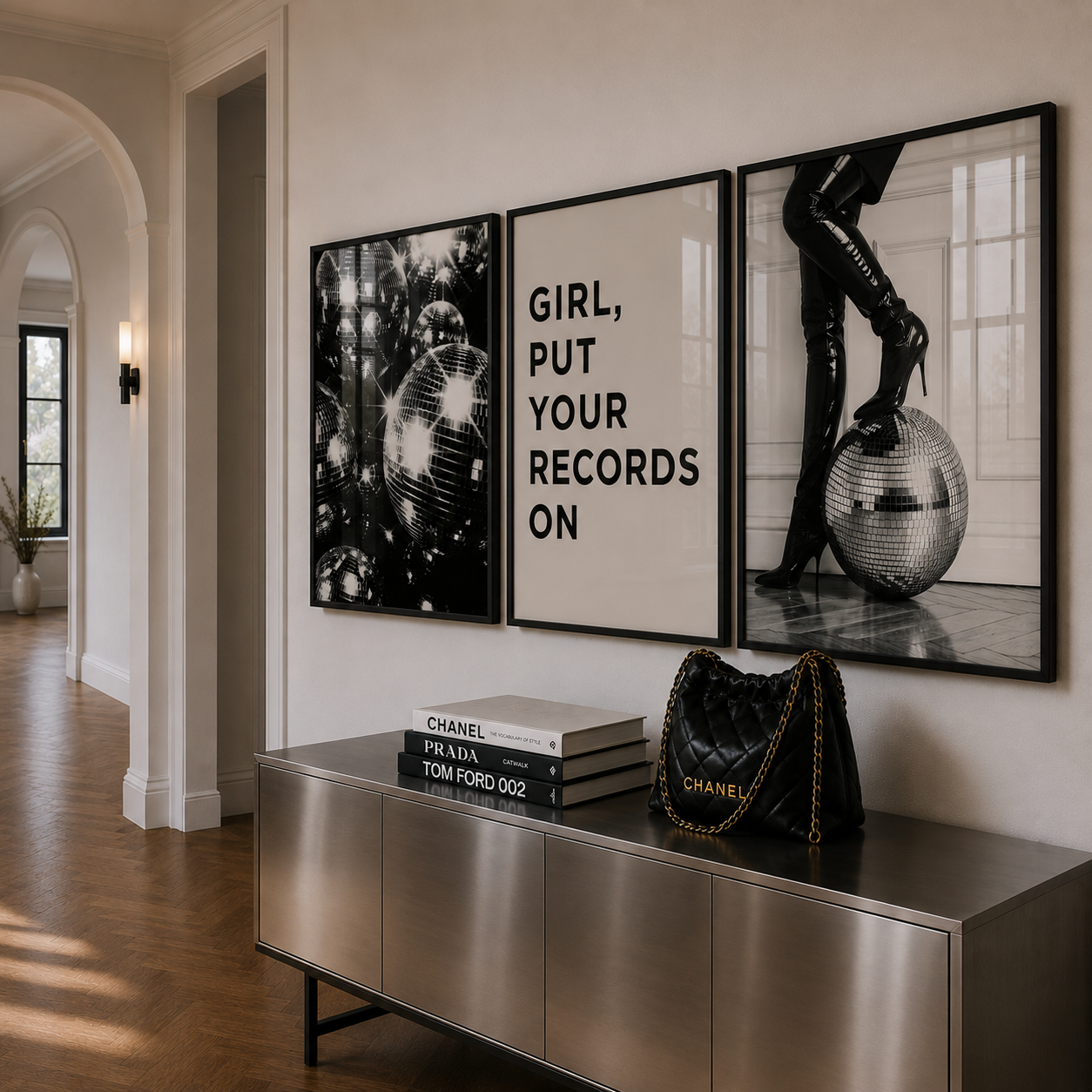 Modern interior with a metallic console table, fashion books, and a Chanel handbag, featuring stylish wall art.