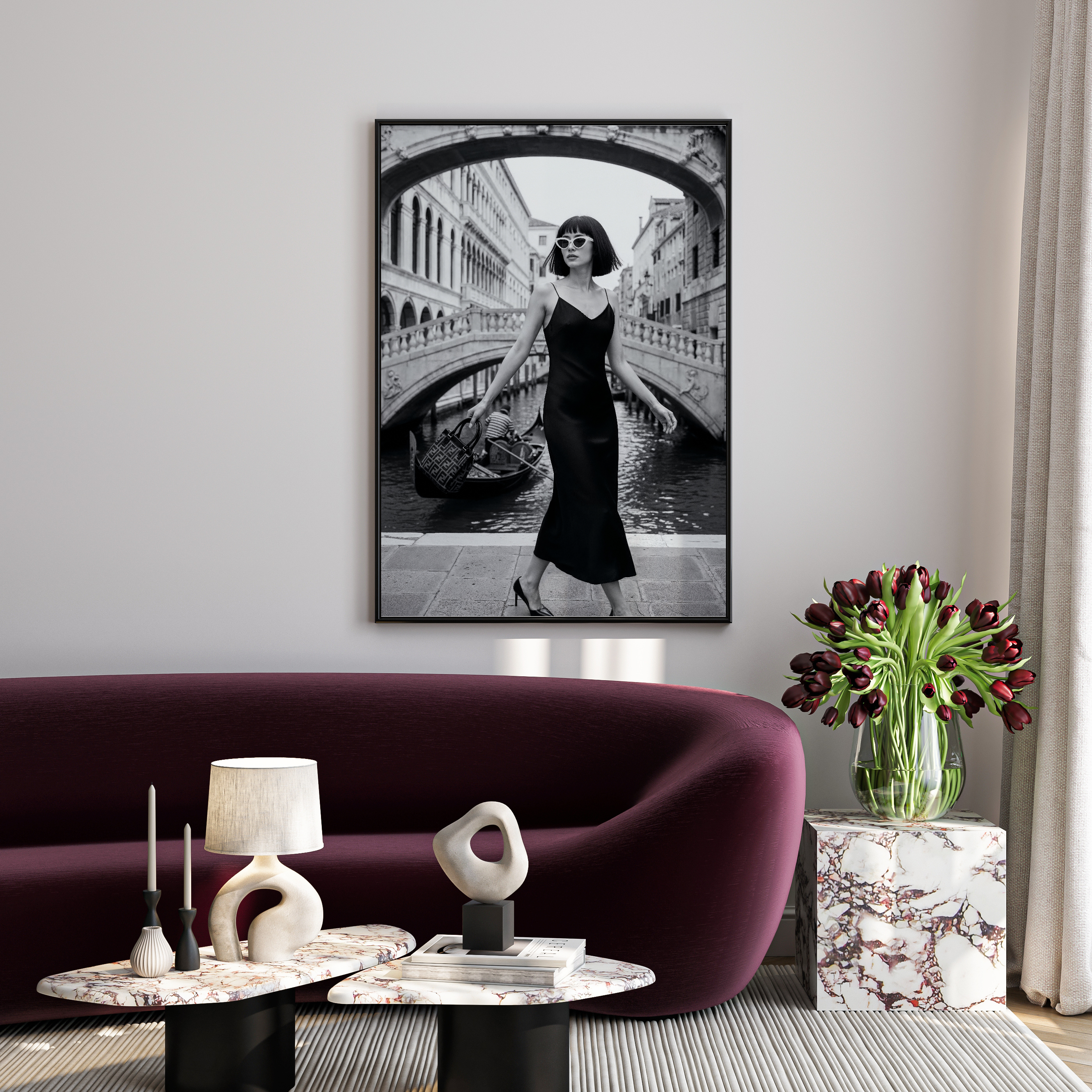 Living room with a purple sofa, marble coffee table, and a framed black and white photo of a woman in a dress.