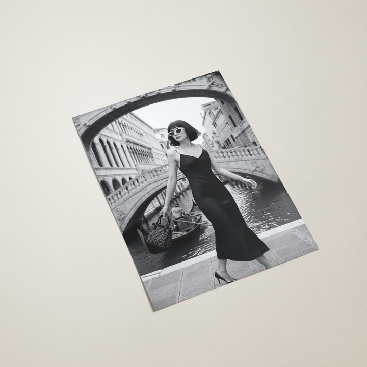 poster with a black and white design of a woman in a dress and sunglasses against a venice background.