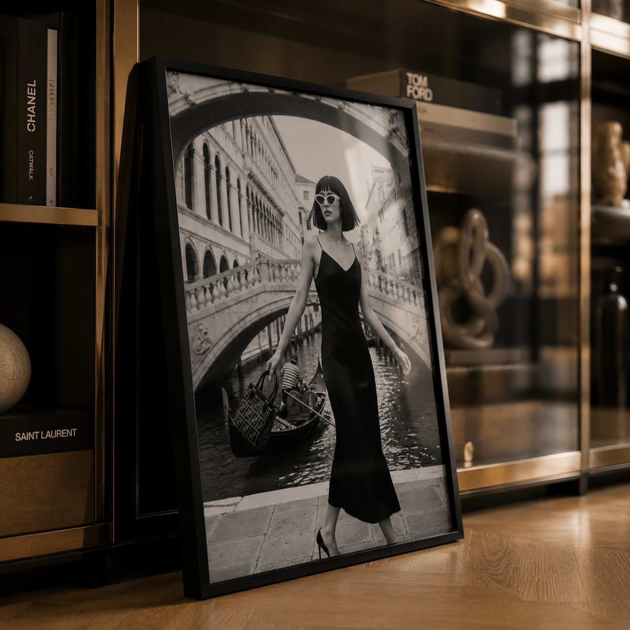Framed black and white art print of a woman in a cityscape setting on a wooden shelf.