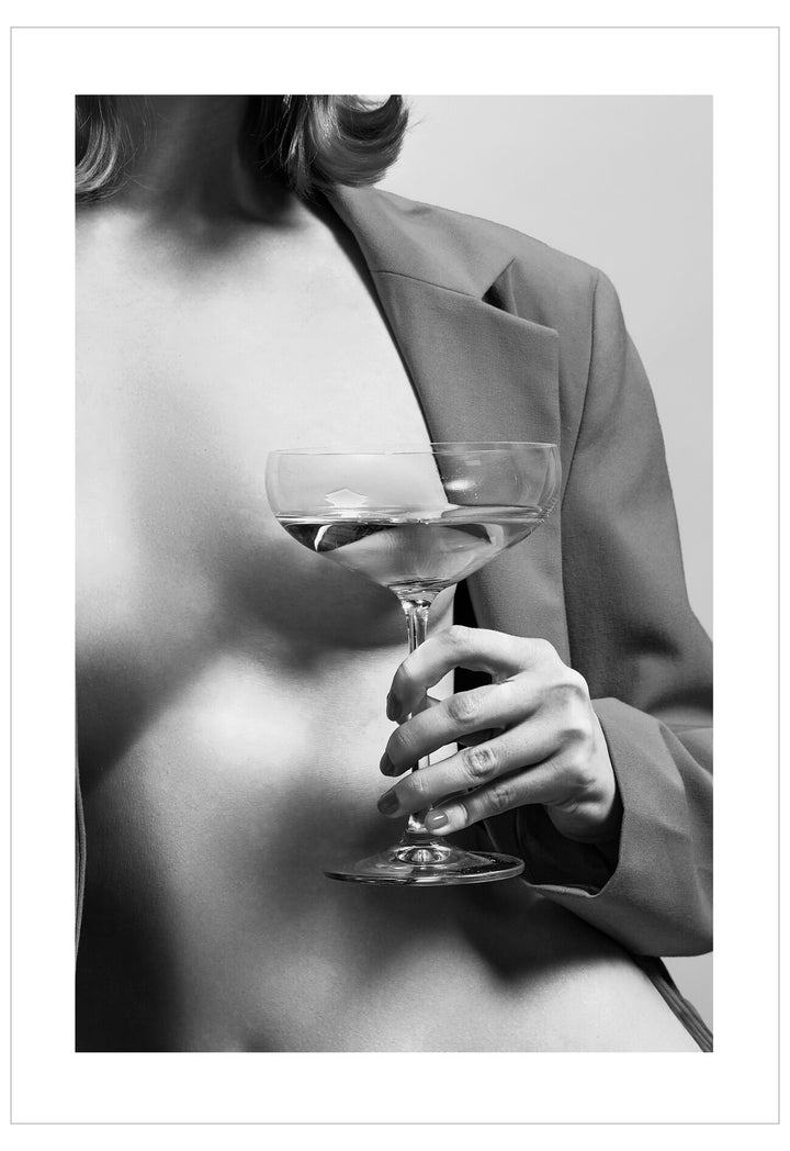 Person holding a cocktail glass with a blurred background