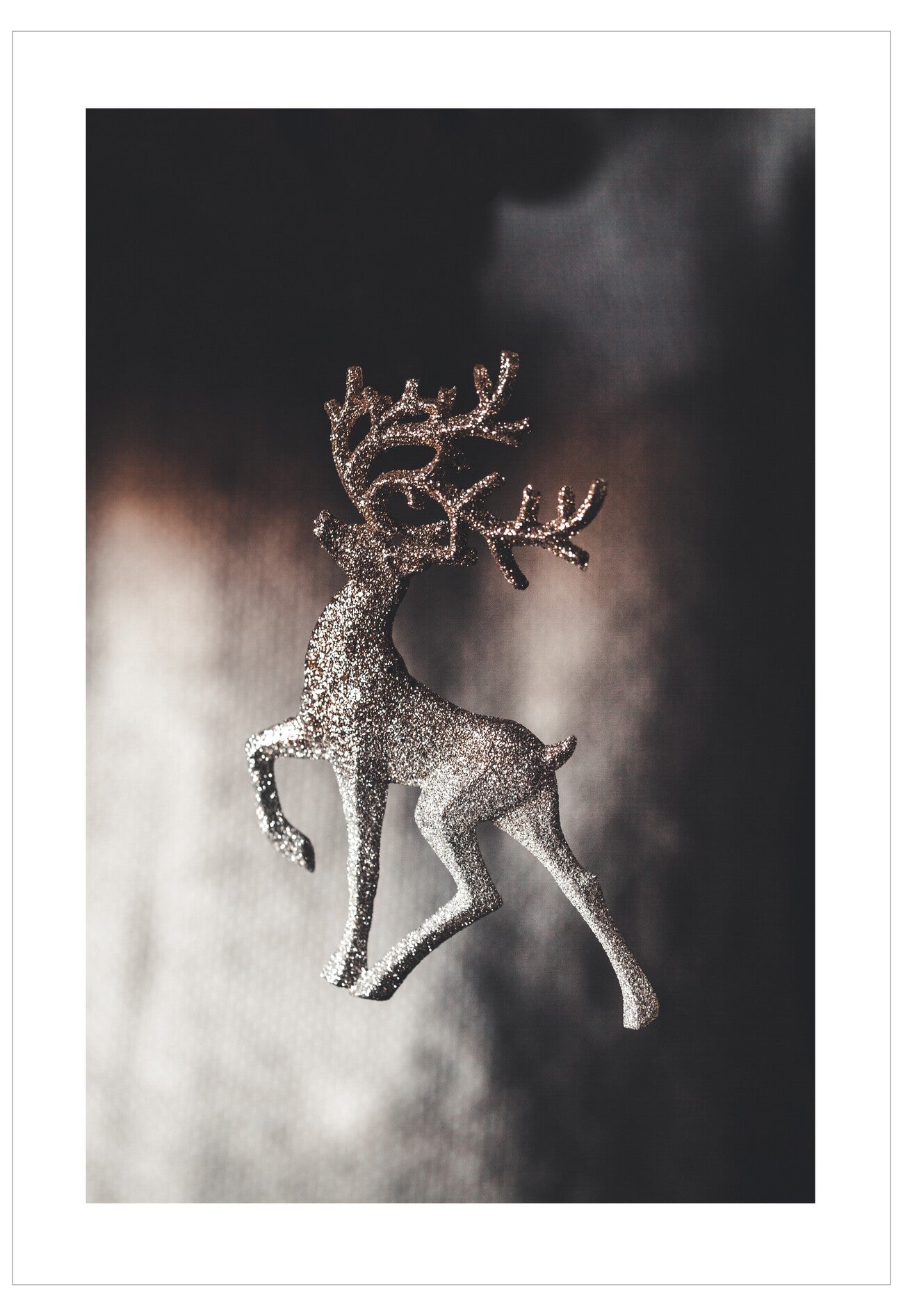 Decorative deer ornament with sparkling antlers on a dark background