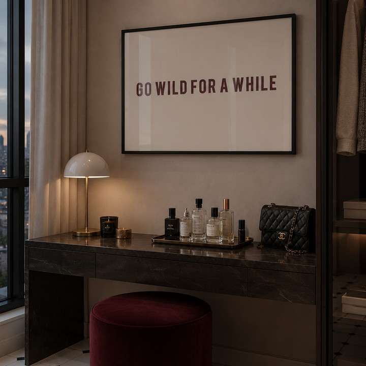 Modern interior with a desk, lamp, and framed quote on a wall.