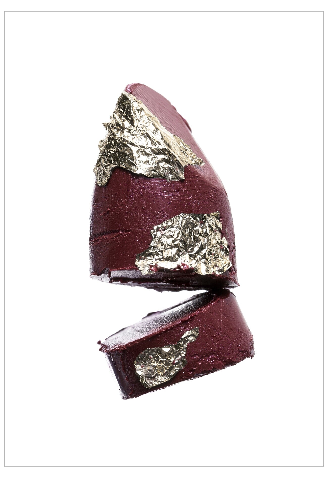 Maroon chocolate bar with gold leaf on a white background