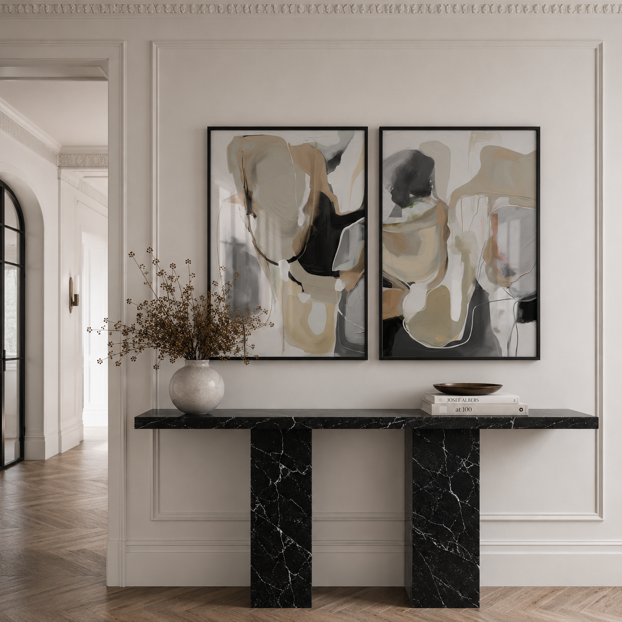 Modern interior with a black marble console table and abstract art on the wall.