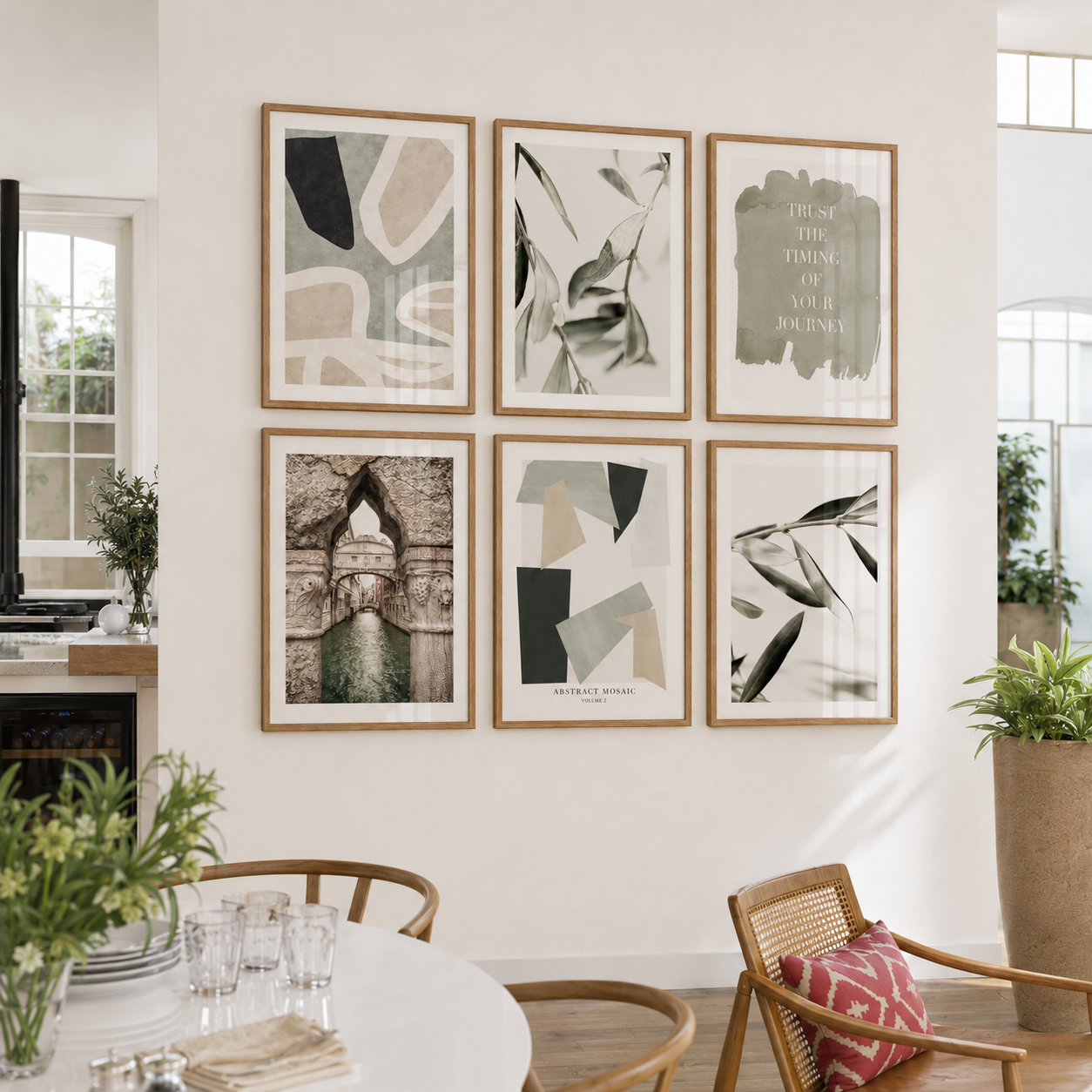 Living room with framed artwork on the wall and a table with glasses and a vase.