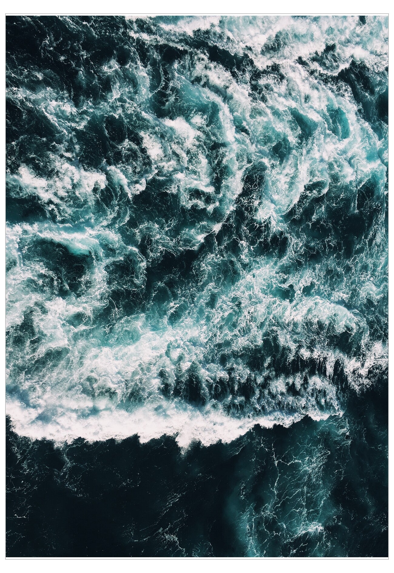 Close-up of turbulent ocean waves with white foam.