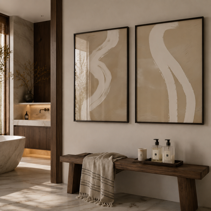 Bathroom interior with abstract wall art, wooden bench, and towels.