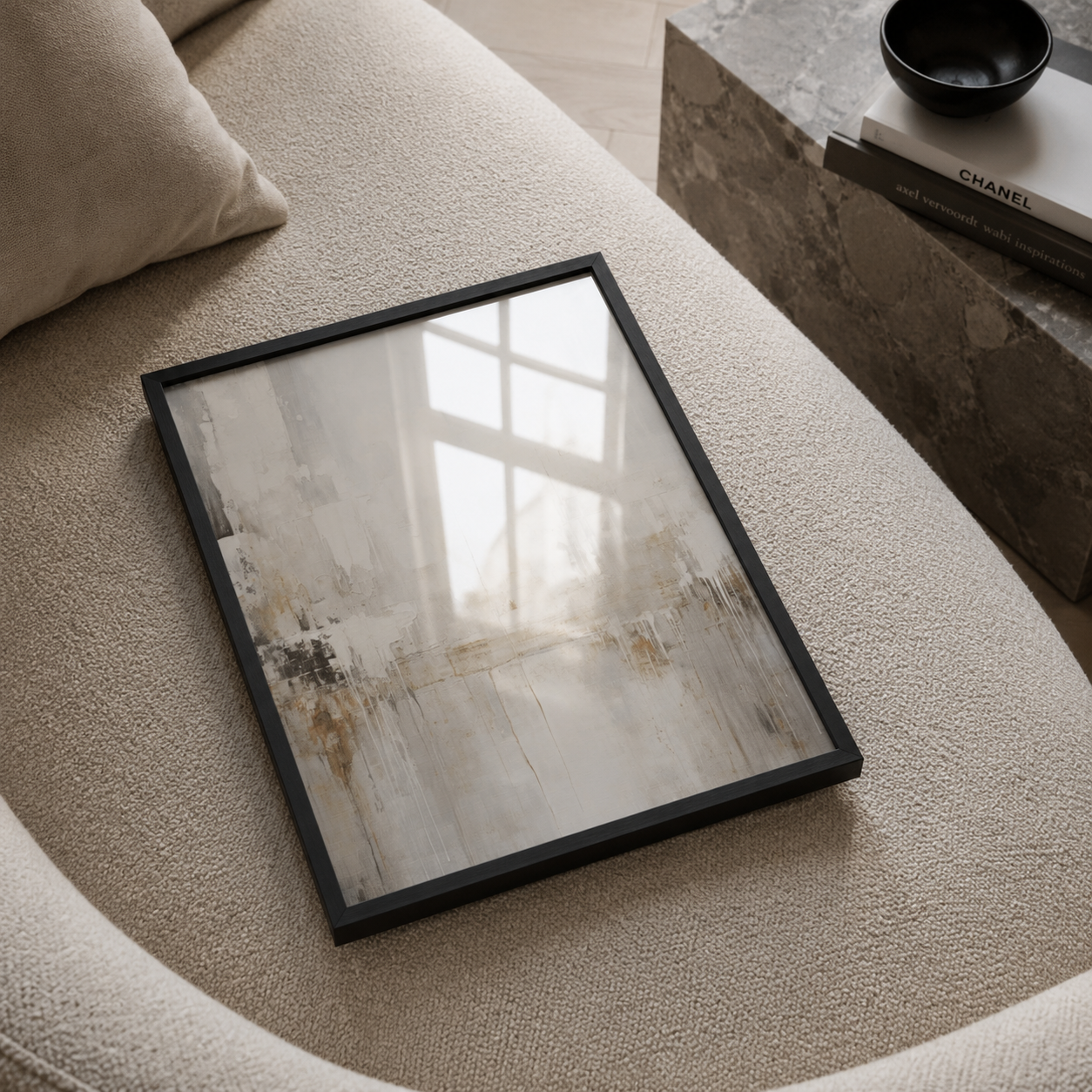 Framed abstract art on a textured surface with a blurred background