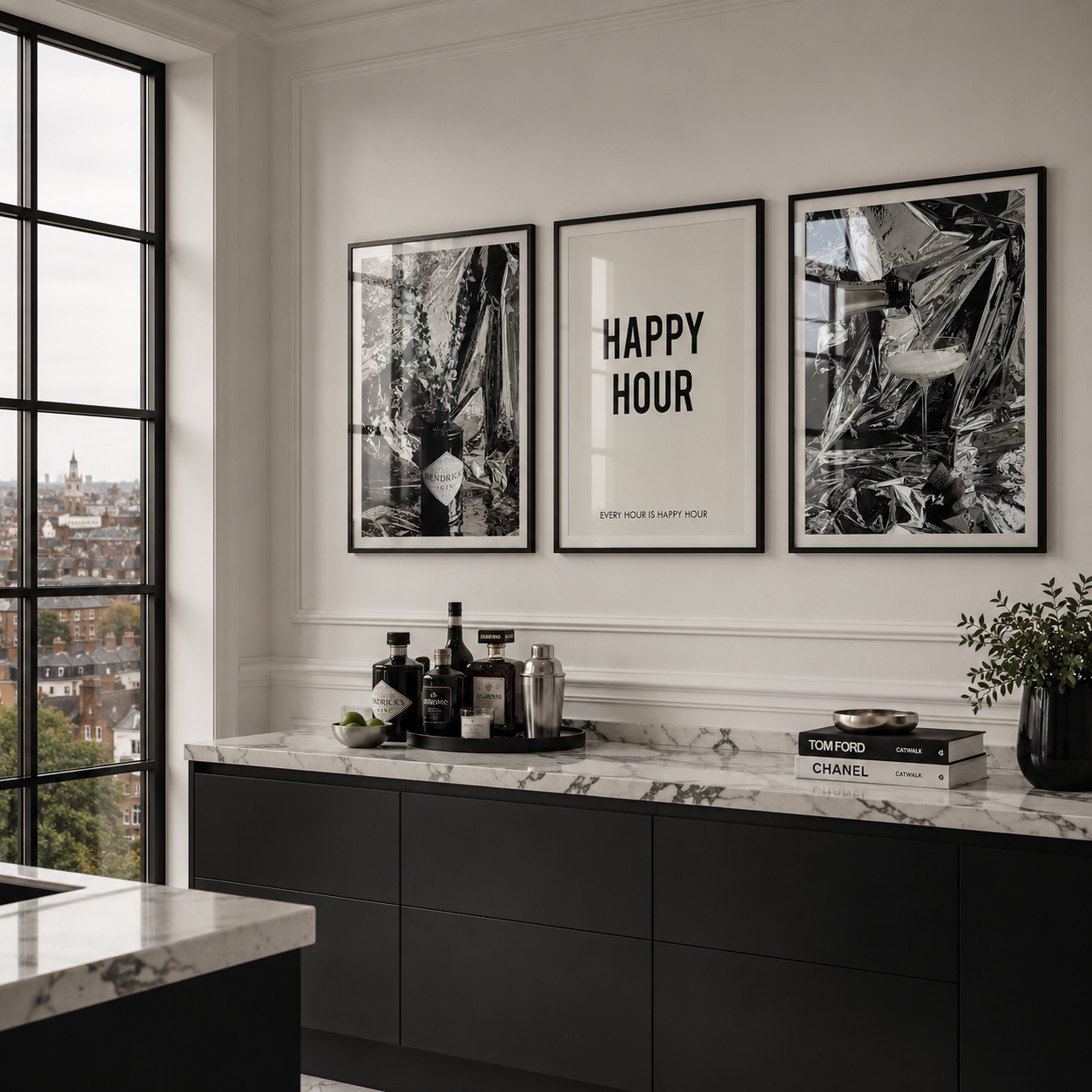 Modern kitchen with black cabinets, marble countertops, and framed artwork on the wall.