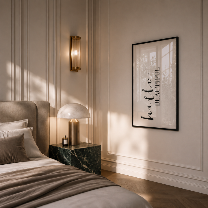 Modern bedroom with a bed, nightstand, wall sconce, and framed artwork.