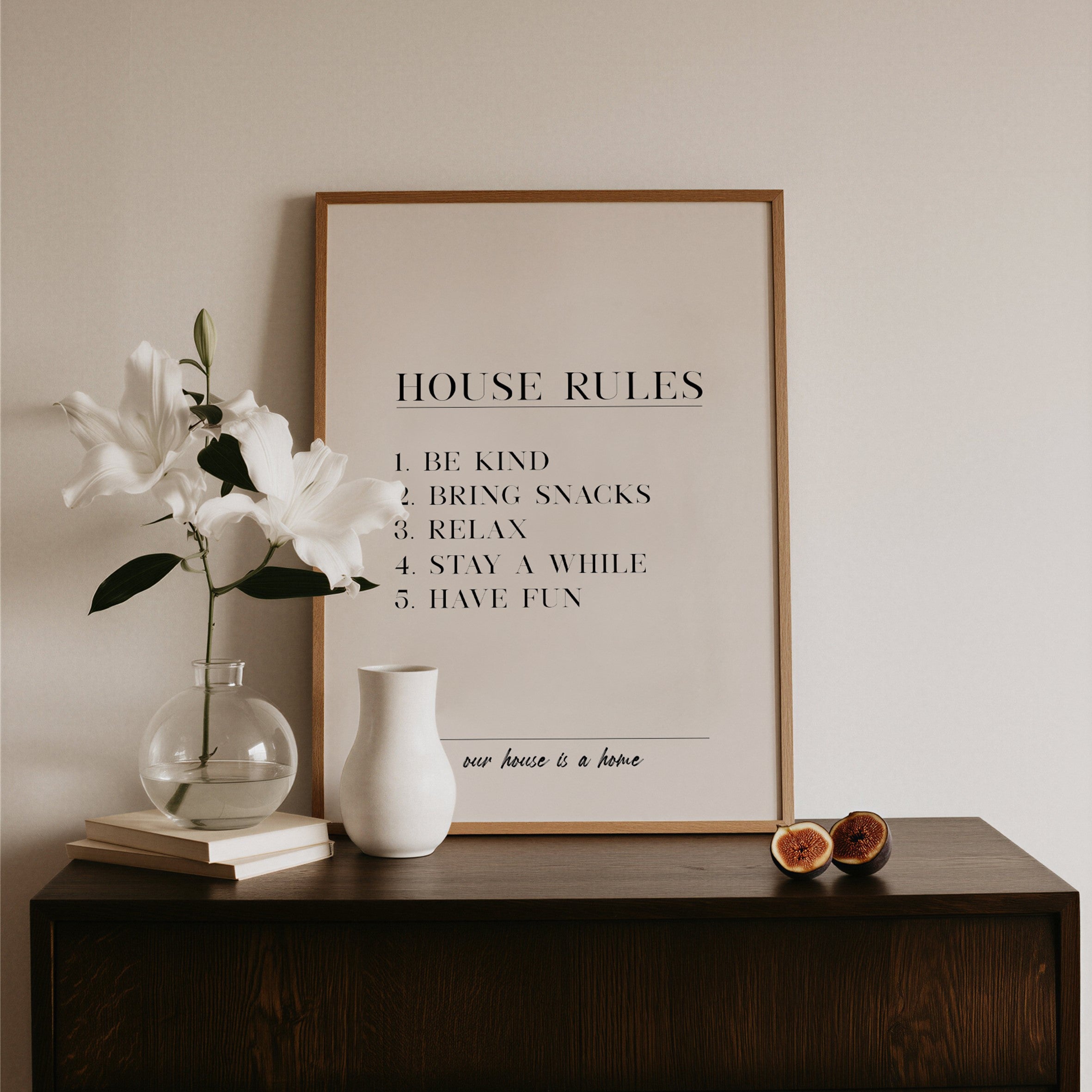 Framed 'House Rules' poster on a wooden surface with decorative items.