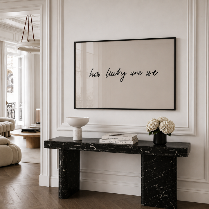 Modern interior with a marble console table and framed artwork on the wall.
