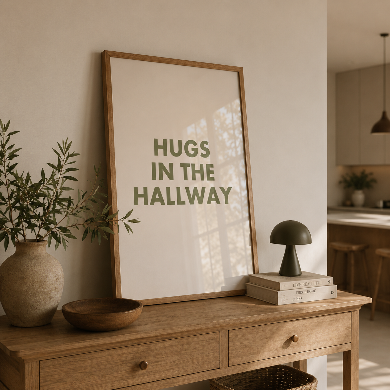 Wooden console table with a framed print titled 'Hugs in the Hallway', a vase, and books in a home setting.