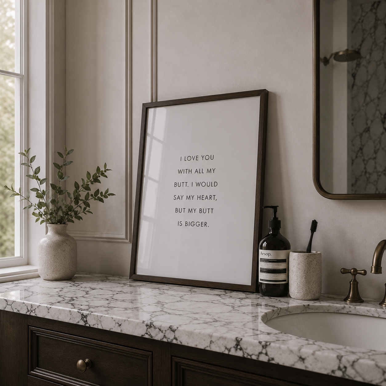 Bathroom counter with framed print, plant, and toiletries